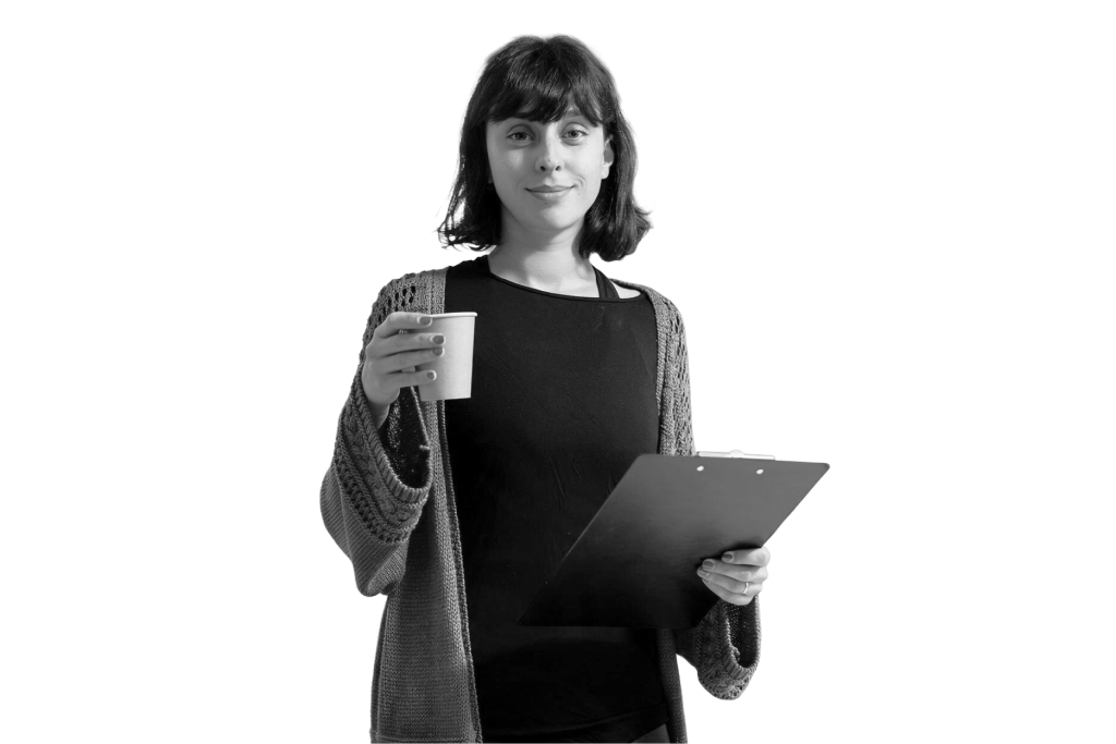 Founder of Ledger holding a coffee cup and a clipboard